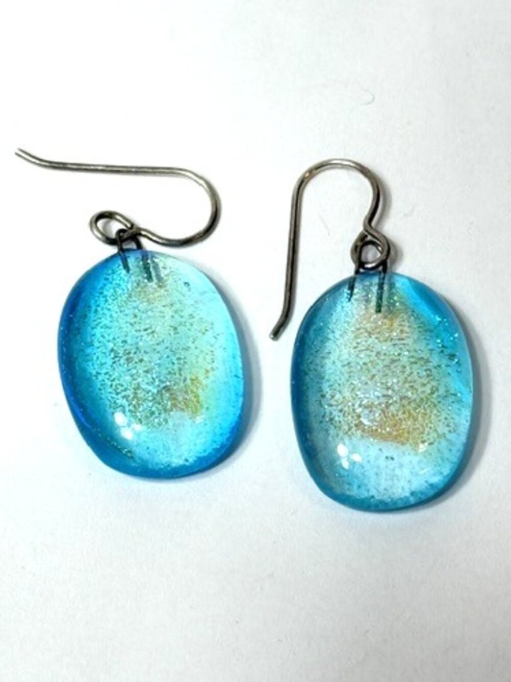 Blue and gold shimmer dichroic oval pierced earrings.
